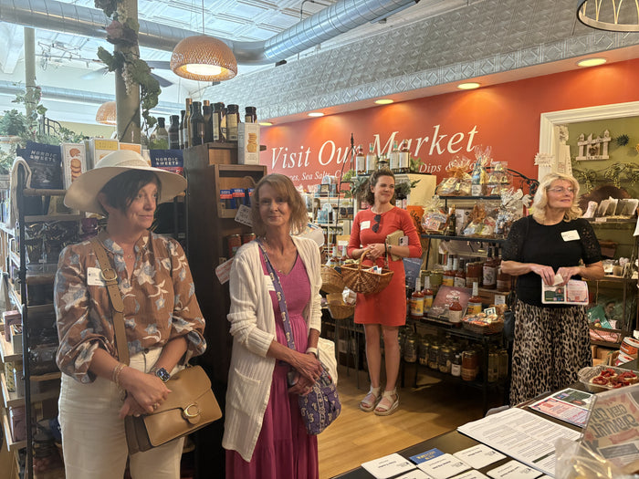 Private event guests touring the pantry and gift shelves at Olive 'n Vinnie's Glen Ellyn market