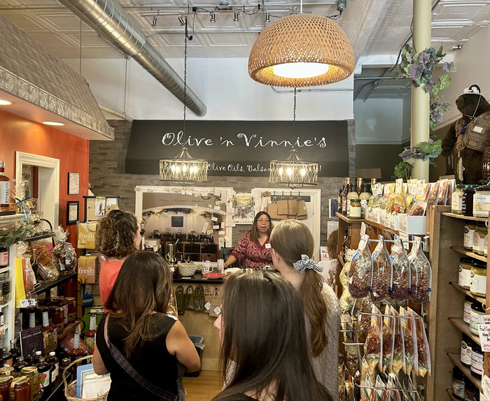 Olive 'n Vinnie's staff leading a guided tasting presentation for a private event group