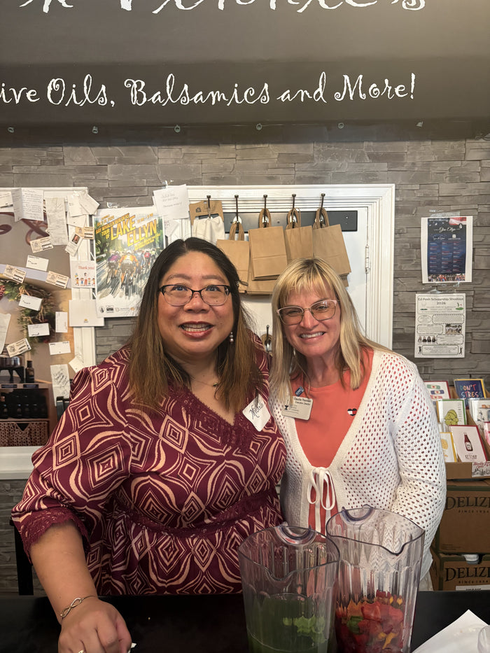 Olive 'n Vinnie's staff members smiling behind an infused water station during a private event