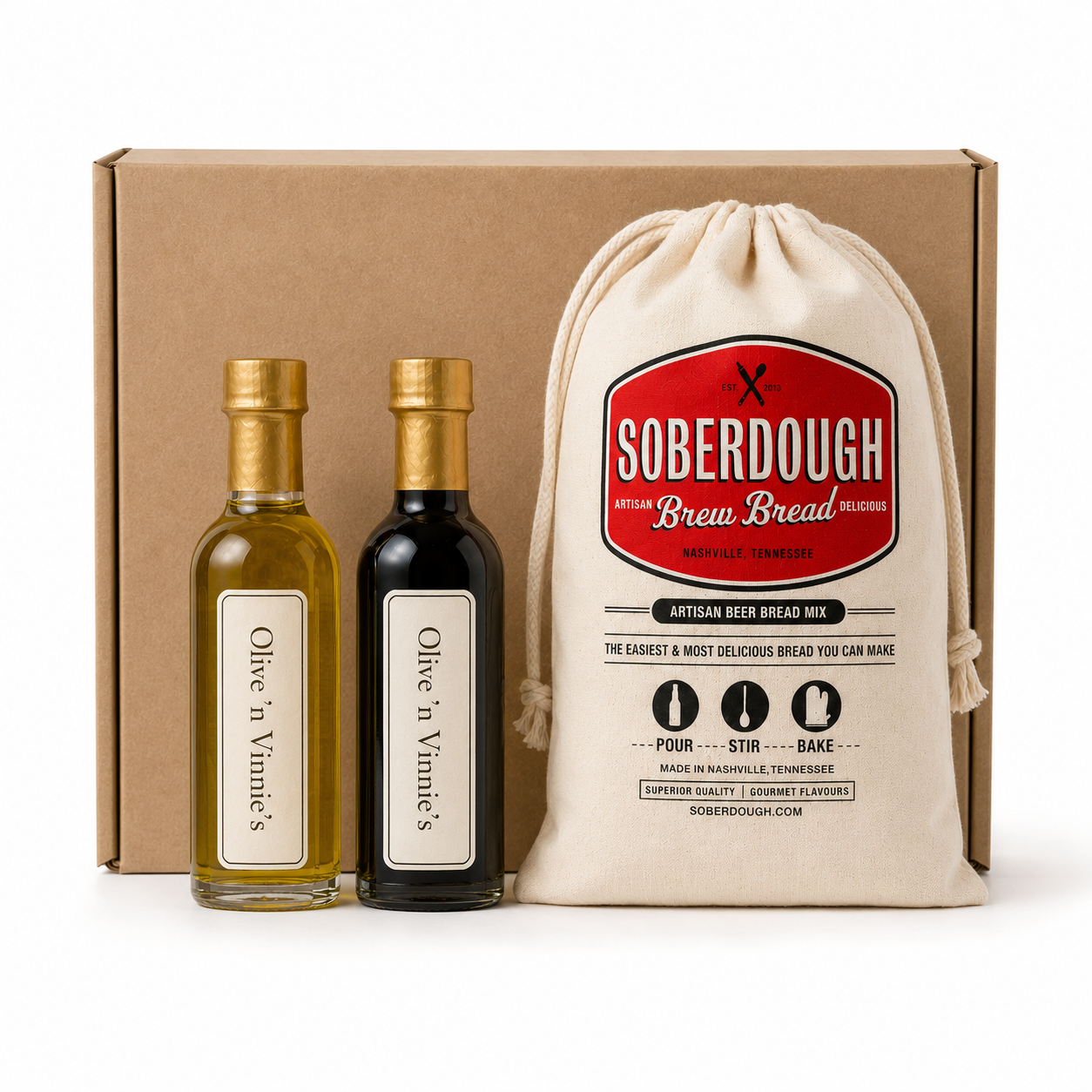 Two Olive 'n Vinnie's mini bottles and Soberdough bread mix in front of a kraft shipping box, Pantry Starter gift box