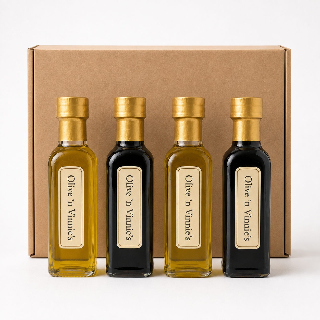 Four Olive 'n Vinnie's mini olive oils and balsamics in front of a kraft shipping box, Sampler gift box