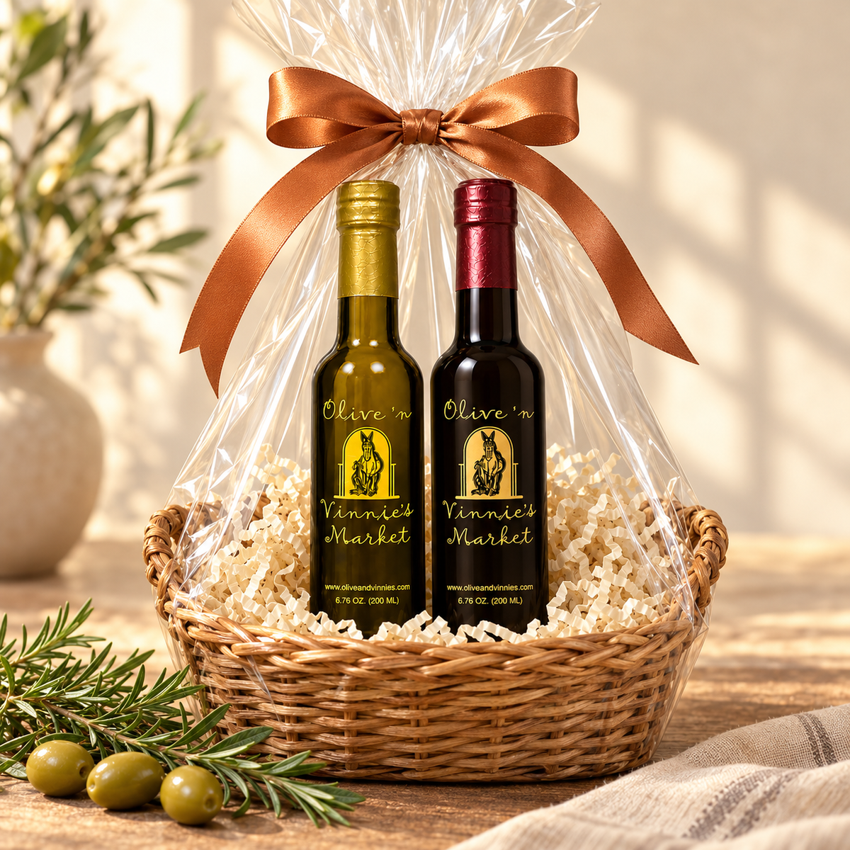 Olive ‘n Vinnie’s olive oil and balsamic gift basket wrapped in cellophane with a copper bow
